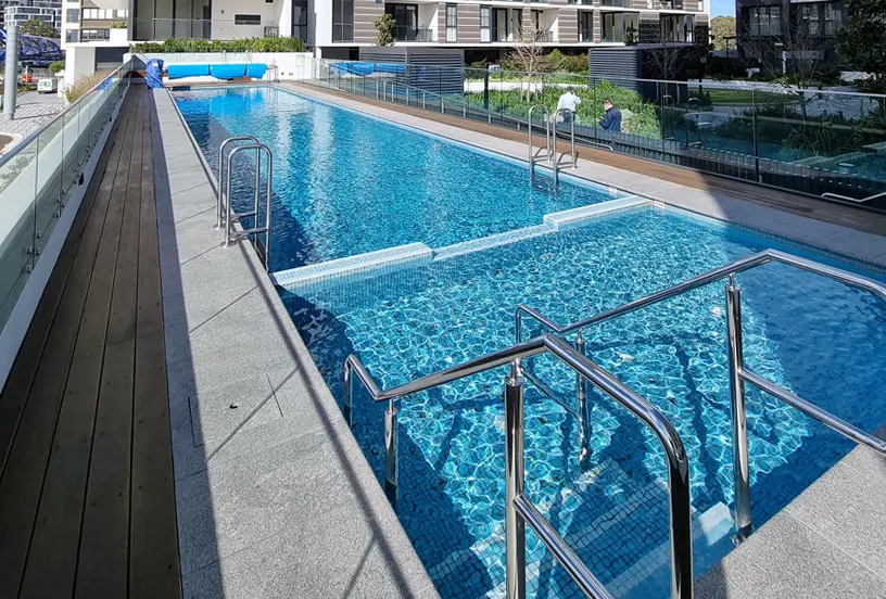 Modern apartment outdoor swimming pool with clear blue water